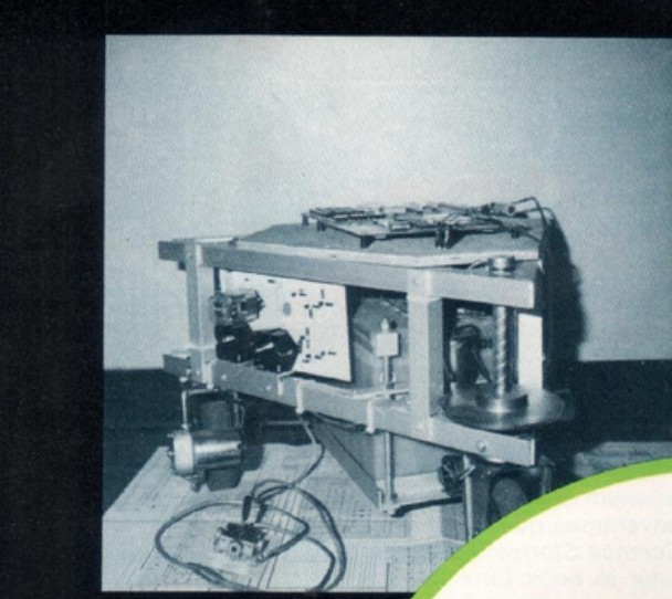 Figure 2 — Three-quarter view of the rolling chassis during construction, showing
the two-tier angle-aluminum frame, an electronics panel mounted between the frame
rails, and the large motorized dr…