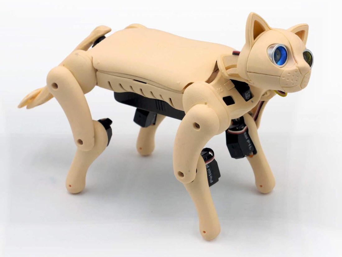 Figure 2 — Nybble Q: eleven joints, a 3D-printed body, and the leg servos visible along the flank with their Petoi-marked leads. Reference only — vendor product image, copyright Petoi LLC; verify b…
