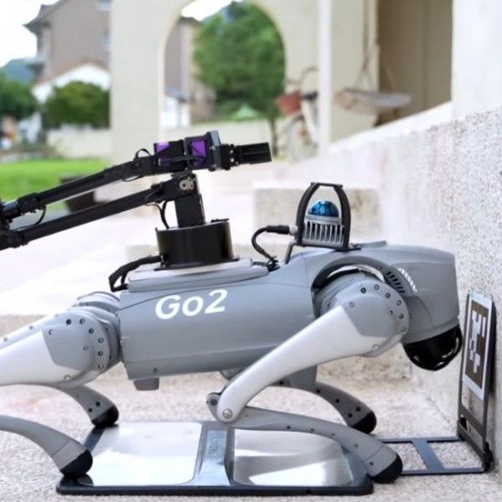 Figure 2 — The Unitree Go2 Charging Station UTGO2CS — a commercial autonomous charging dock for the Go2 quadruped (reference only). The low-profile outdoor unit delivers 33.6 V / 9 A via contact pads. Autonom…
